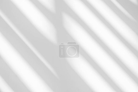 Abstract light reflection and grey shadow from window on white wall background. Gray stripe window shadows and sunshine diagonal geometric overlay effect for backdrop and mockup desig