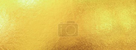 Gold wall texture background. Yellow shiny gold foil paper sheet surface, vibrant golden luxury wallpaper