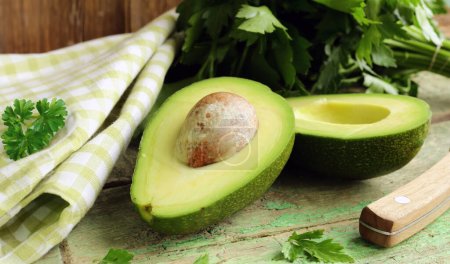 Photo for Organic natural healthy avocado on wooden table - Royalty Free Image