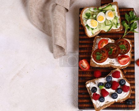 Photo for Various sandwiches for a healthy diet on a wooden board - Royalty Free Image