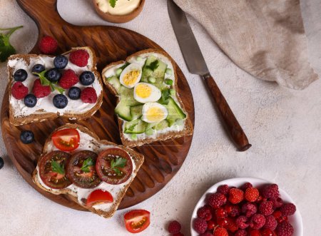 Photo for Various sandwiches for a healthy diet on a wooden board - Royalty Free Image