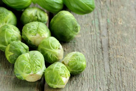 Photo for Fresh organic brussels sprouts on wooden table - Royalty Free Image