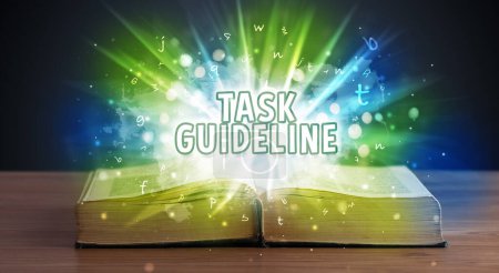 Photo for TASK GUIDELINE inscription coming out from an open book, educational concept - Royalty Free Image