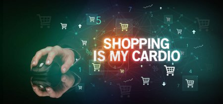 Photo for Hand holding wireless peripheral with SHOPPING IS MY CARDIO inscription, online shopping concept - Royalty Free Image