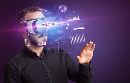 Photo for Businessman looking through Virtual Reality glasses with OBJECTIVE inscription, new business concept - Royalty Free Image