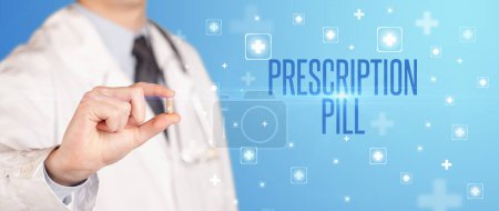 Photo for Close-up of a doctor giving a pill with PRESCRIPTION PILL inscription, medical concept - Royalty Free Image