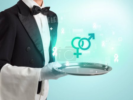 Photo for Handsome young waiter in tuxedo holding tray with gender icon icons on tray, global healthcare concept - Royalty Free Image