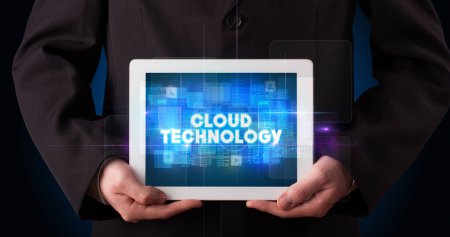 Photo for Young business person working on tablet and shows the inscription: CLOUD TECHNOLOGY - Royalty Free Image