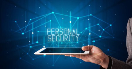 Photo for Young business person working on tablet and shows the digital sign: PERSONAL SECURITY - Royalty Free Image