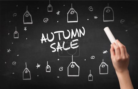 Photo for Hand drawing AUTUMN SALE inscription with white chalk on blackboard, online shopping concept - Royalty Free Image