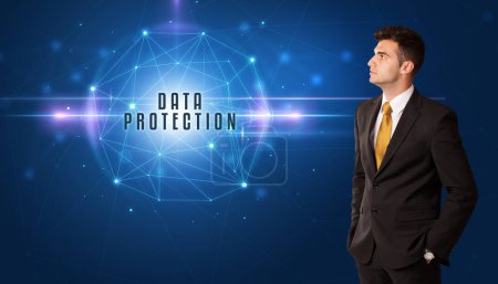Photo for Businessman thinking about security solutions with DATA PROTECTION inscription - Royalty Free Image