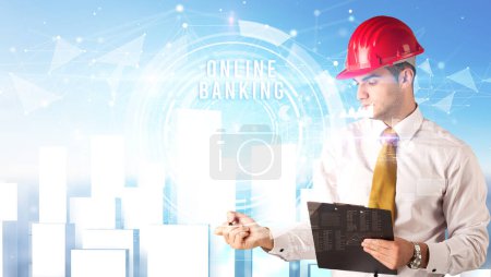 Photo for Handsome businessman with helmet drawing ONLINE BANKING inscription, contruction business concept - Royalty Free Image