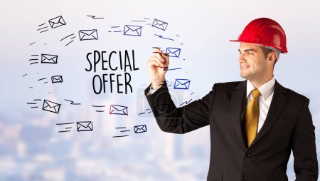 Photo for Handsome businessman with helmet drawing SPECIAL OFFER inscription, contruction sale concept - Royalty Free Image