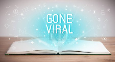 Photo for Open book with GONE VIRAL inscription, social media concept - Royalty Free Image