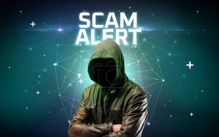 Photo for Mysterious hacker with SCAM ALERT inscription, online attack concept inscription, online security concept - Royalty Free Image