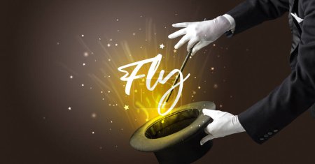 Photo for Magician is showing magic trick with Fly inscription, traveling concept - Royalty Free Image