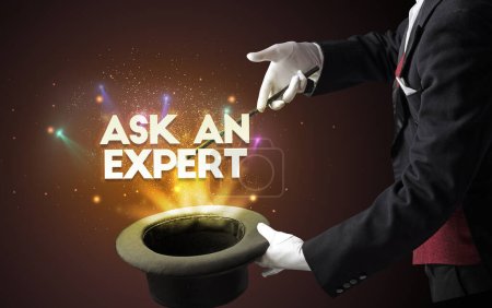 Photo for Illusionist is showing magic trick with ASK AN EXPERT inscription, new business model concept - Royalty Free Image