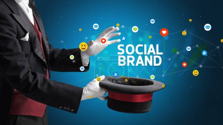 Photo for Magician is showing magic trick with SOCIAL BRAND inscription, social media marketing concept - Royalty Free Image