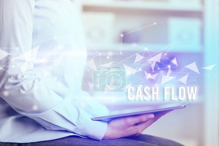 Photo for Close up hands using tablet with CASH FLOW inscription, modern business technology concept - Royalty Free Image