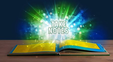 Photo for TAKE NOTES inscription coming out from an open book, educational concept - Royalty Free Image