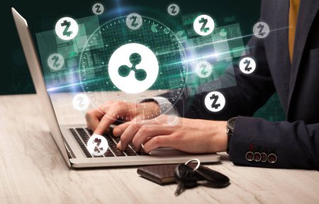 Photo for Business hand working in stock market with ripple icons coming out from laptop screen - Royalty Free Image