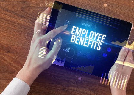 Photo for Close-up of hands holding tablet with EMPLOYEE BENEFITS inscription, modern business concept - Royalty Free Image