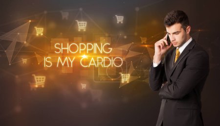 Businessman with shopping cart icons and SHOPPING IS MY CARDIO inscription, online shopping concept