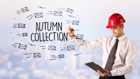 Photo for Handsome businessman with helmet drawing AUTUMN COLLECTION inscription, contruction sale concept - Royalty Free Image