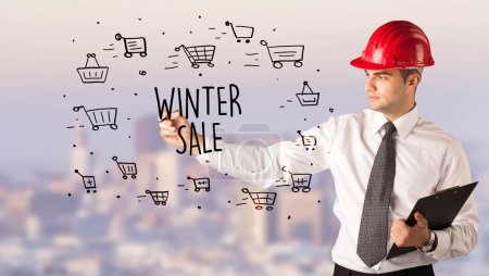 Photo for Handsome businessman with helmet drawing WINTER SALE inscription, contruction sale concept - Royalty Free Image