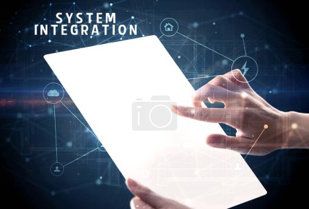 Photo for Holding futuristic tablet with SYSTEM INTEGRATION inscription, cyber security concept - Royalty Free Image