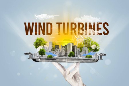 Foto de Camarero sirviendo eco ciudad con inscripción WIND TURBINES, concepto de energía renovable - Imagen libre de derechos