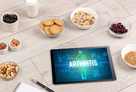 Photo for ARTHRITIS concept in tablet with fruits, top view - Royalty Free Image
