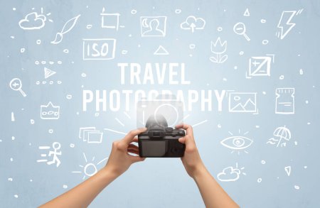 Photo for Hand taking picture with digital camera and TRAVEL PHOTOGRAPHY inscription, camera settings concept - Royalty Free Image