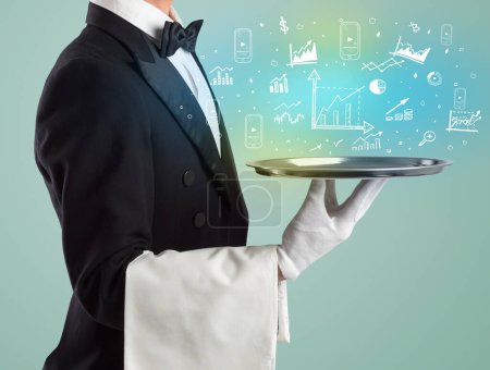 Handsome young waiter in tuxedo holding tray with chart icons on tray, global market concept
