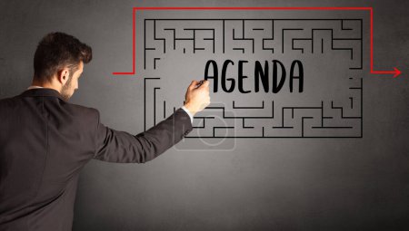 Photo for Businessman drawing maze with AGENDA inscription, business education concept - Royalty Free Image