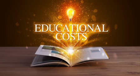 Photo for EDUCATIONAL COSTS inscription coming out from an open book, educational concept - Royalty Free Image