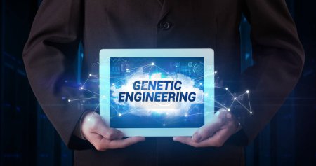 Photo for Young business person working on tablet and shows the inscription: GENETIC ENGINEERING - Royalty Free Image