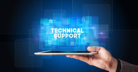 Photo for Young business person working on tablet and shows the inscription: TECHNICAL SUPPORT - Royalty Free Image