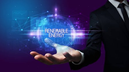 Photo for Man hand holding RENEWABLE ENERGY inscription, technology concept - Royalty Free Image