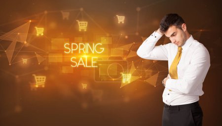 Photo for Businessman with shopping cart icons and SPRING SALE inscription, online shopping concept - Royalty Free Image