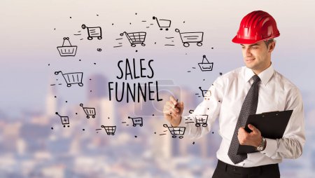 Photo for Handsome businessman with helmet drawing SALES FUNNEL inscription, contruction sale concept - Royalty Free Image