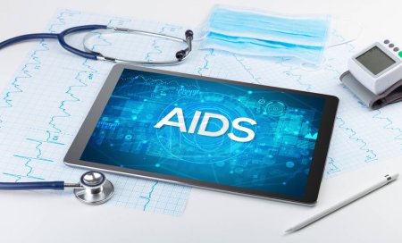Photo for Close-up view of a tablet pc with AIDS abbreviation, medical concept - Royalty Free Image