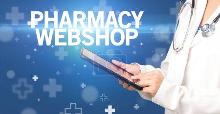 Photo for Doctor writes notes on the clipboard with PHARMACY WEBSHOP inscription, first aid concept - Royalty Free Image