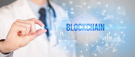 Photo for Doctor giving a pill with BLOCKCHAIN inscription, new technology solution concept - Royalty Free Image