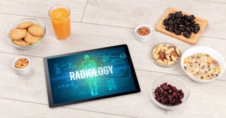 Photo for RADIOLOGY concept in tablet with fruits, top view - Royalty Free Image