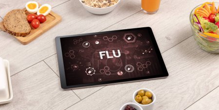 Photo for Healthy Tablet Pc compostion with FLU inscription, immune system boost concept - Royalty Free Image