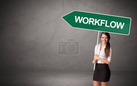 Photo for Young business person in casual holding road sign with WORKFLOW inscription, new business direction concept - Royalty Free Image