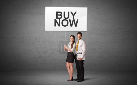 Photo for Business person holding a traffic sign with BUY NOW inscription, new idea concept - Royalty Free Image