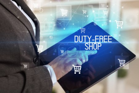 Photo for Young person makes a purchase through online shopping application with DUTY-FREE SHOP inscription - Royalty Free Image