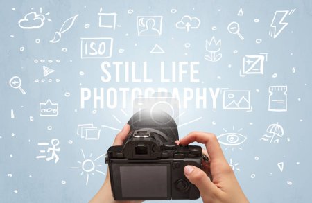 Photo for Hand taking picture with digital camera and STILL LIFE PHOTOGRAPHY inscription, camera settings concept - Royalty Free Image